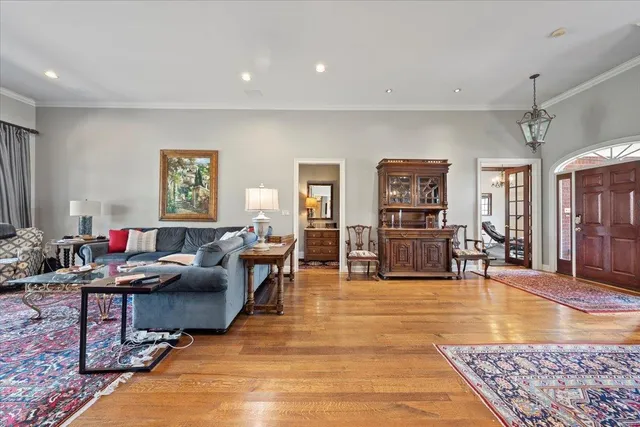 a living room with furniture and a wooden floor