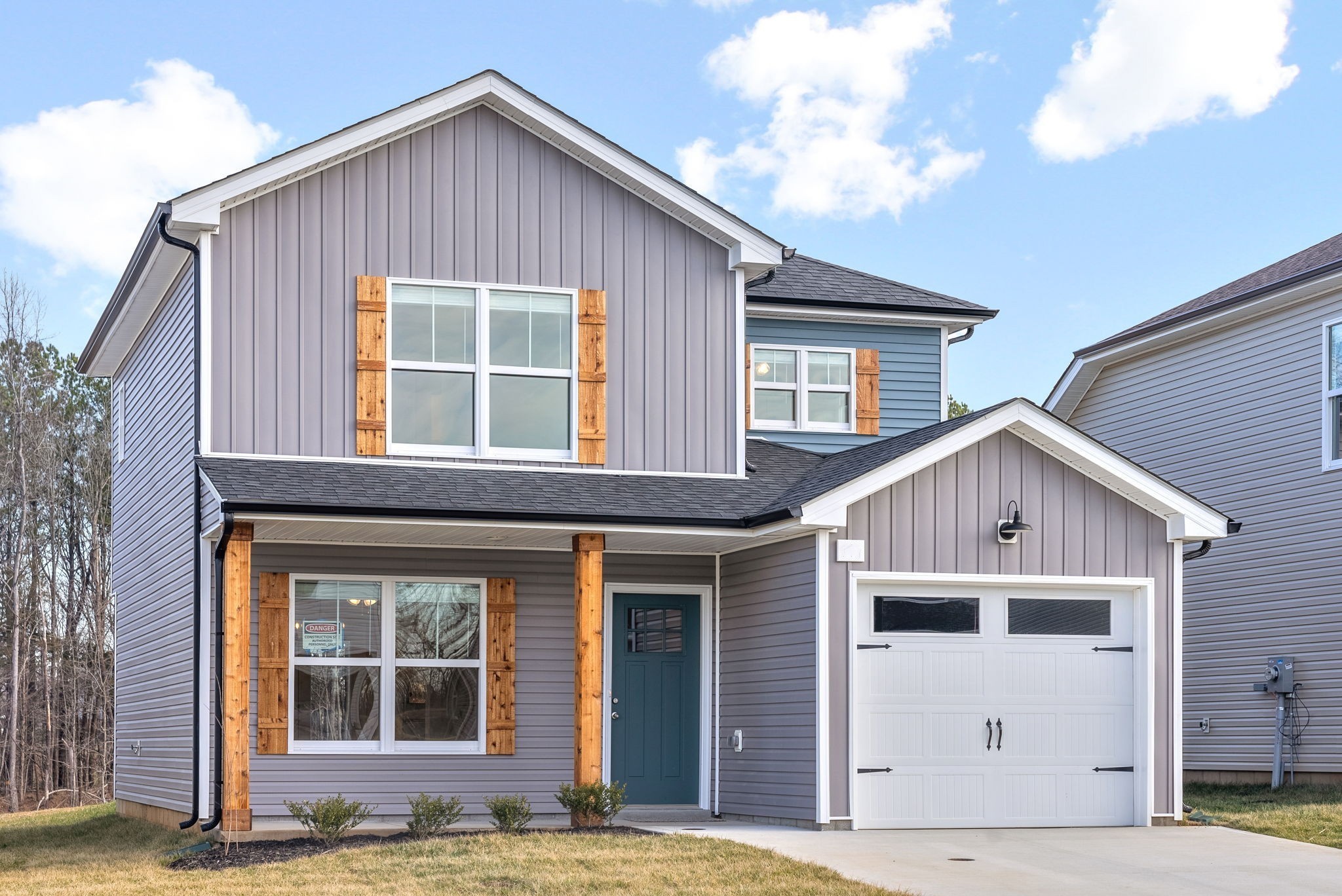 a view of a house with wooden fence and large windows
