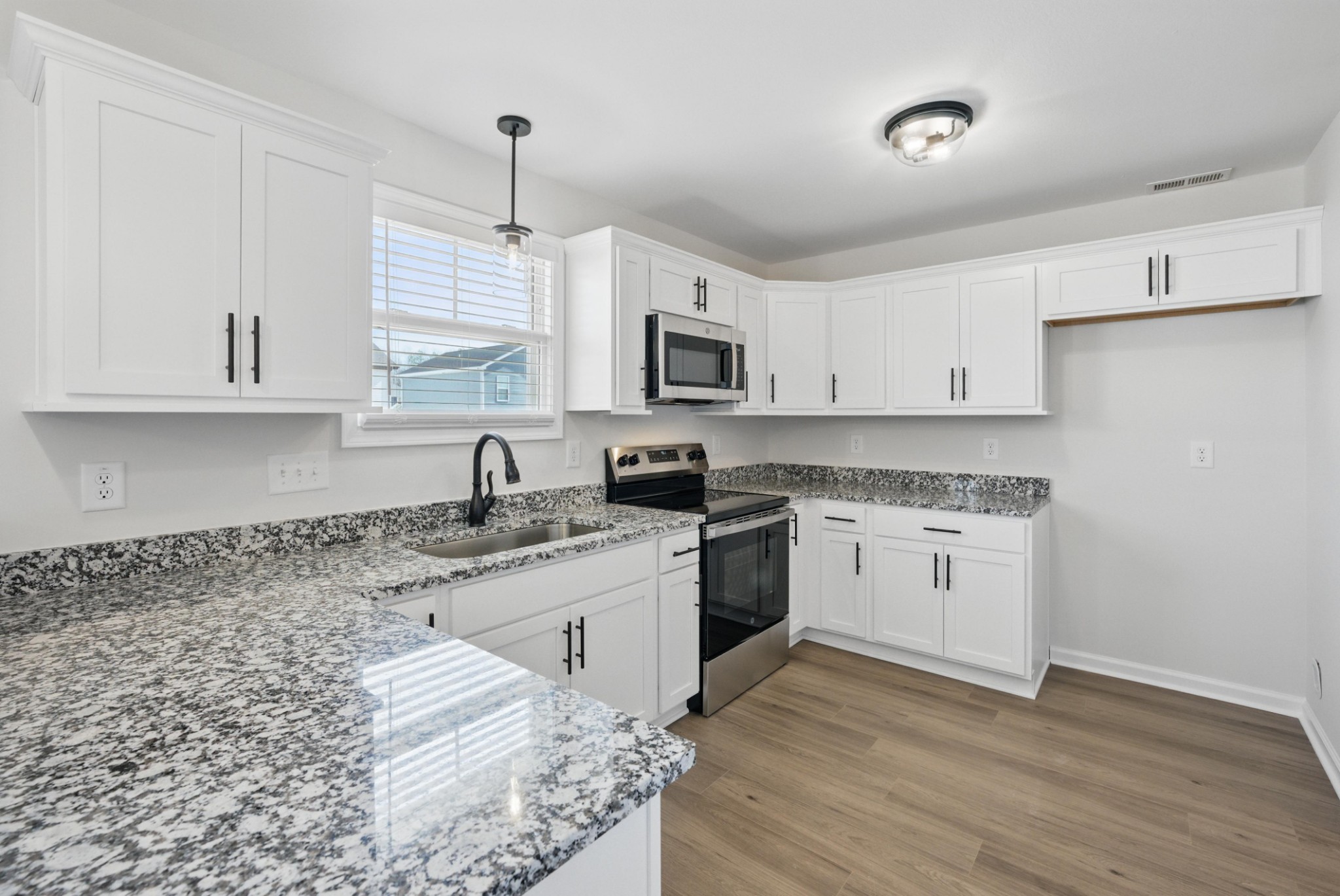 180 Quarry Rdg Road Clarksville, TN 37043 - Photo 3 of 8 a kitchen with granite countertop a sink cabinets a window and stainless steel appliances