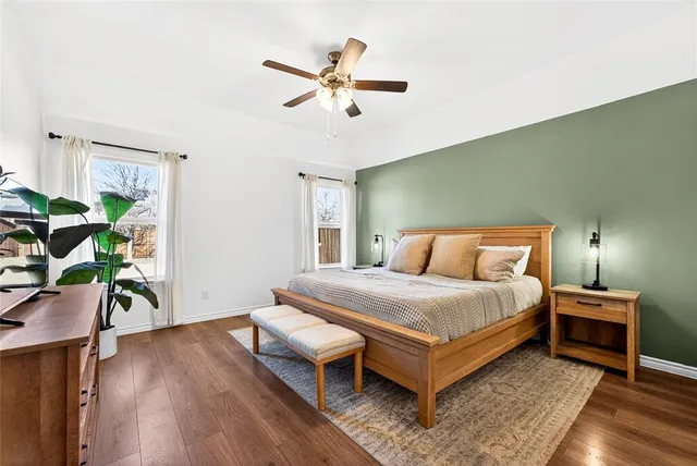 a view of a kitchen with cabinets stainless steel appliances and wooden floor
