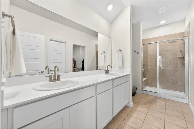 a bedroom with a bed and a potted plant