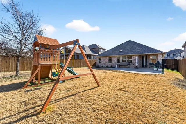 a view of a patio with table and chairs near a barn