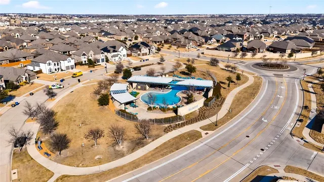 an aerial view of a house with a swimming pool