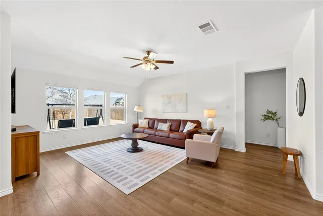 a living room with furniture and wooden floor