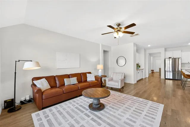 a living room with furniture a window and a table