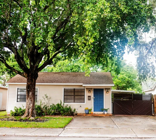 a front view of a house with a garden