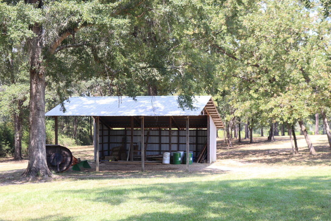 261 Wilkerson Road DeFuniak Springs, FL 32433 - Photo 9 of 15 a view of a house with a yard and tree s