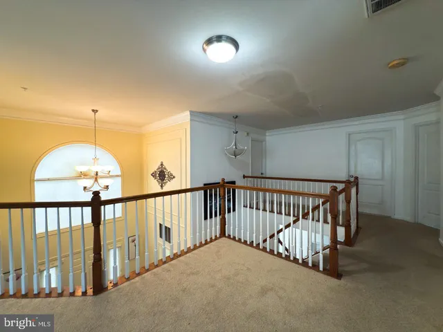 a bedroom with windows and a chandelier fan