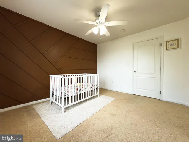 a large living room with a large window and a flat screen tv