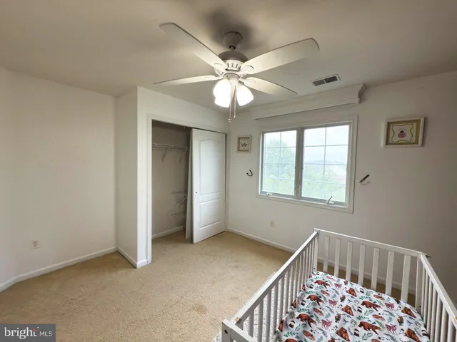 a bed sitting in a bedroom next to a window