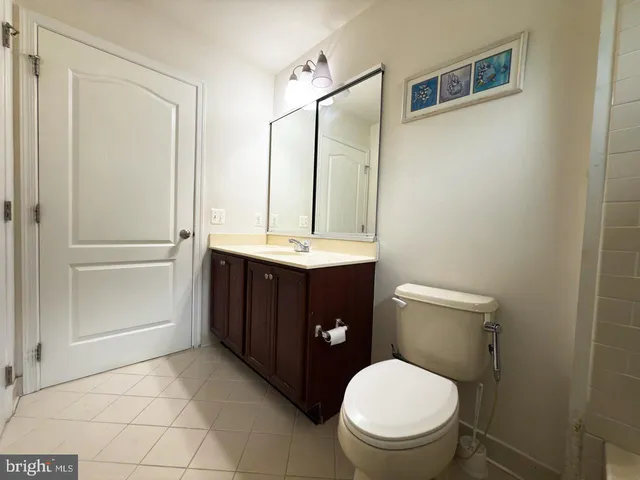 an empty room with a ceiling fan and a window