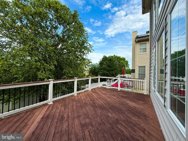 a view of a house with deck and wooden floor