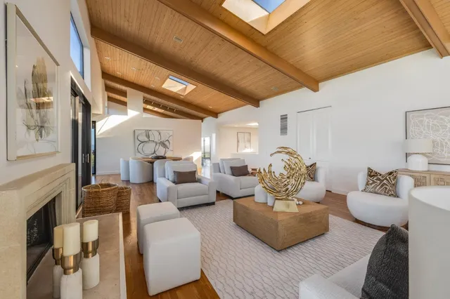 a living room with furniture fireplace and a chandelier