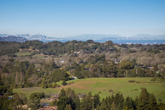 a dining room with furniture and a floor to ceiling window