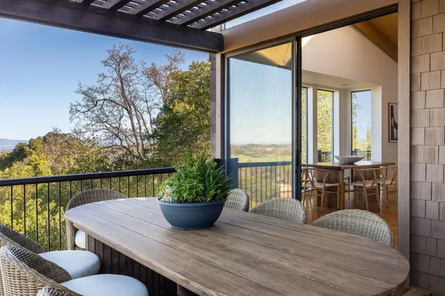 a view of a balcony with table and chairs