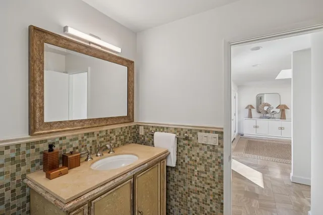 a bathroom with double sink and a mirror