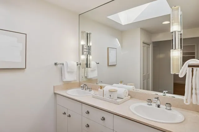 a living room with furniture a potted plant and a fireplace
