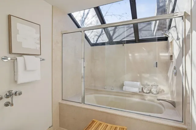 a living room with furniture large window and fireplace