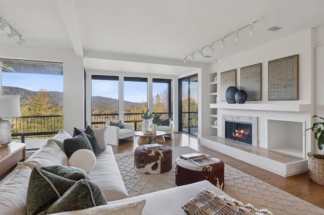 a bedroom with two beds and large windows