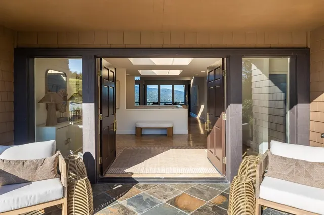 a living room with furniture a rug and white walls