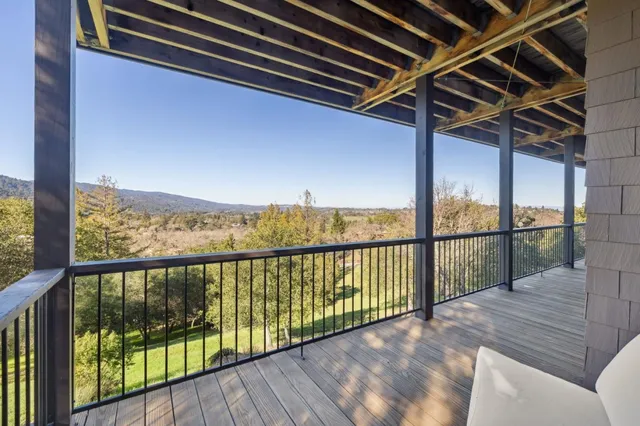 a living room with furniture fireplace and a large window