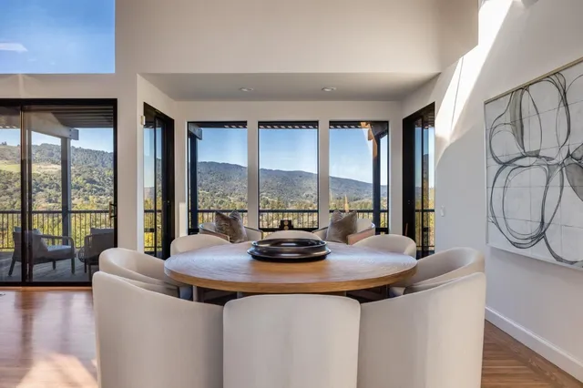 a view of living room with furniture and large windows