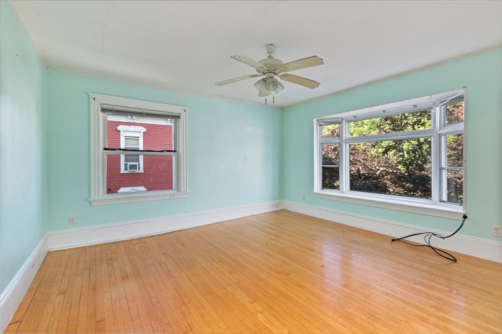 98 Webster Street Haverhill, MA 01830 - Photo 29 of 42 a view of an empty room with wooden floor and a window