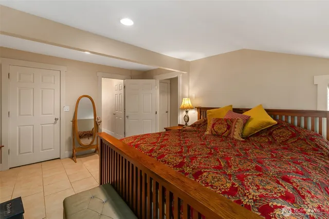 a bedroom with a bed and a large window