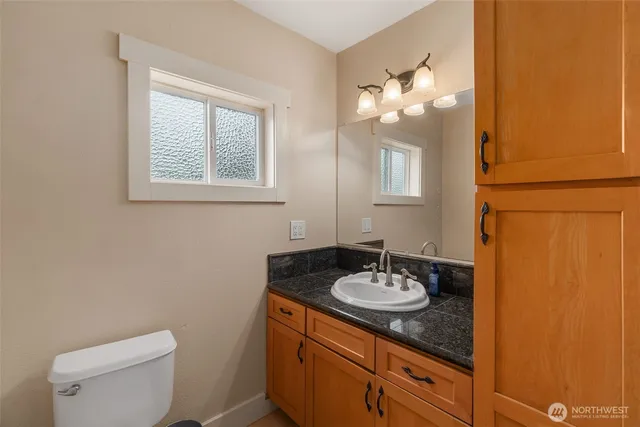 a bathroom with a sink vanity and a mirror