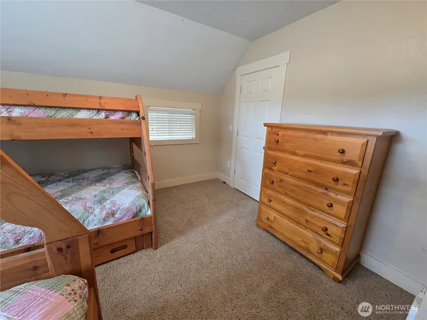 a bedroom with bed and a window