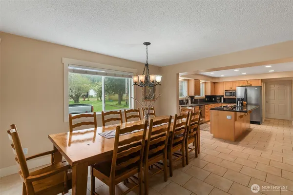 a kitchen with stainless steel appliances granite countertop a sink and a refrigerator