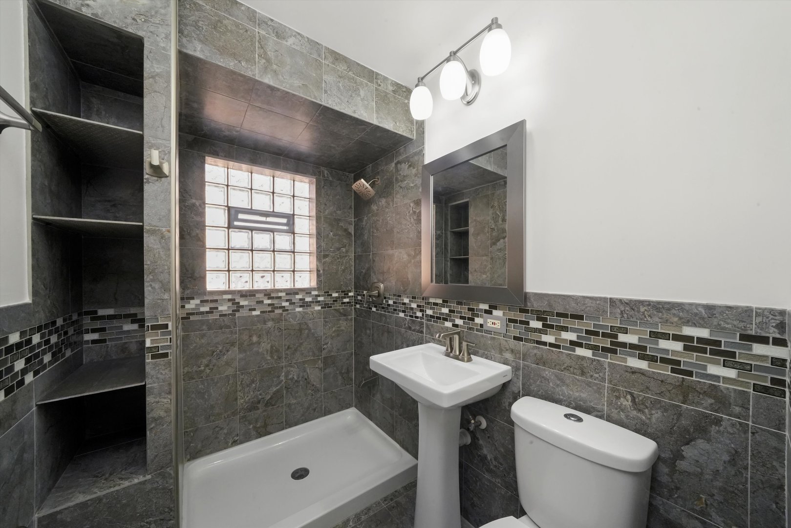 4353 West Marquette Road Chicago, IL 60629 - Photo 12 of 47 a bathroom with a toilet a sink and mirror