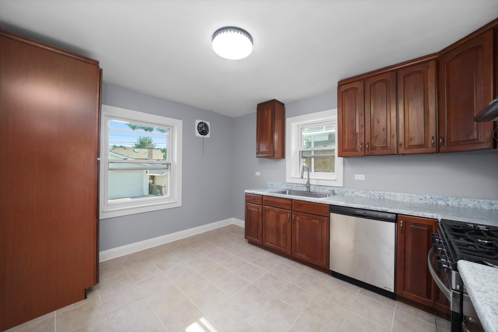 4353 West Marquette Road Chicago, IL 60629 - Photo 15 of 47 a kitchen with stainless steel appliances granite countertop wooden cabinets a sink and dishwasher