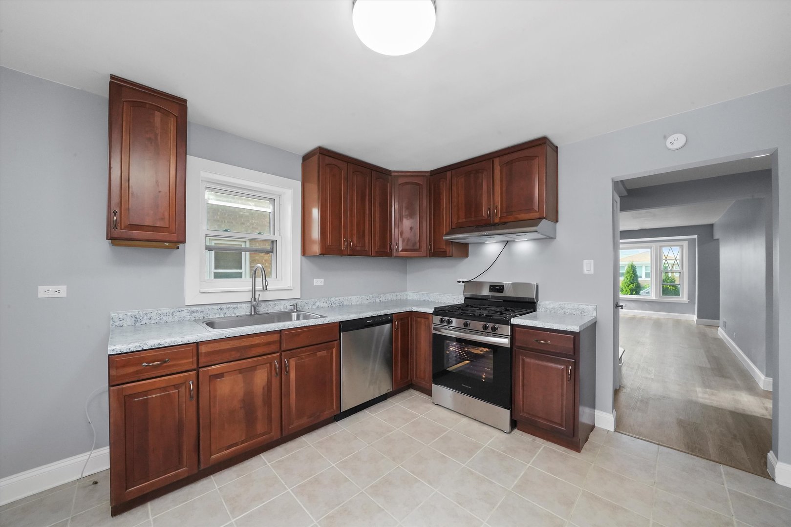 4353 West Marquette Road Chicago, IL 60629 - Photo 17 of 47 a kitchen with stainless steel appliances granite countertop a sink stove and cabinets