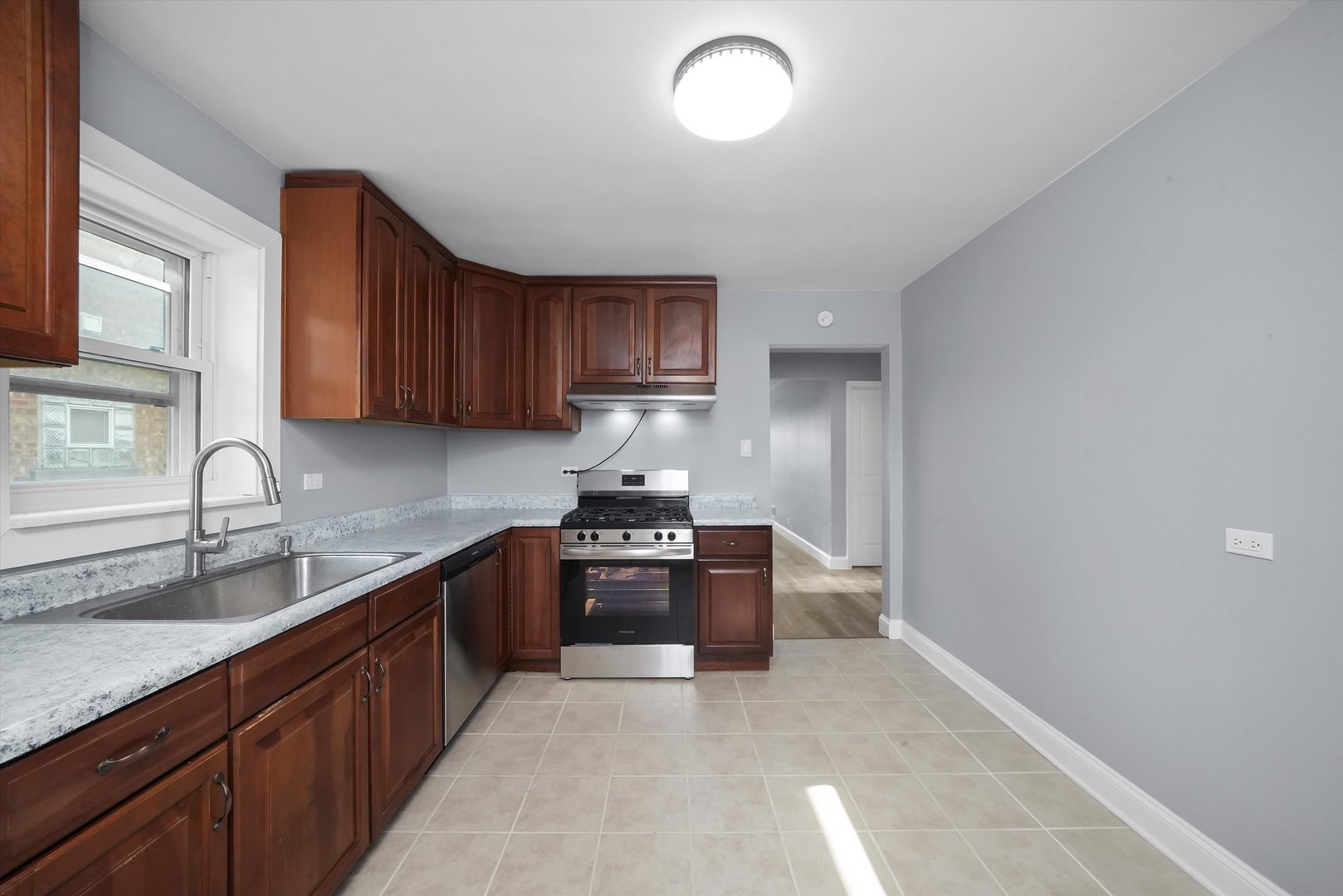 4353 West Marquette Road Chicago, IL 60629 - Photo 18 of 47 a kitchen with stainless steel appliances granite countertop a sink stove and cabinets
