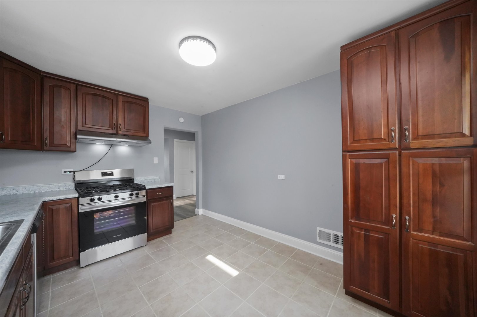 4353 West Marquette Road Chicago, IL 60629 - Photo 19 of 47 a kitchen with wooden cabinets and stainless steel appliances