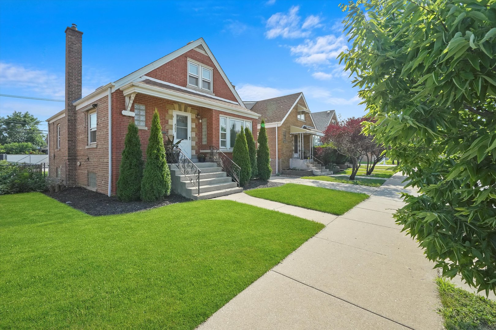 4353 West Marquette Road Chicago, IL 60629 - Photo 3 of 47 a front view of a house with a yard