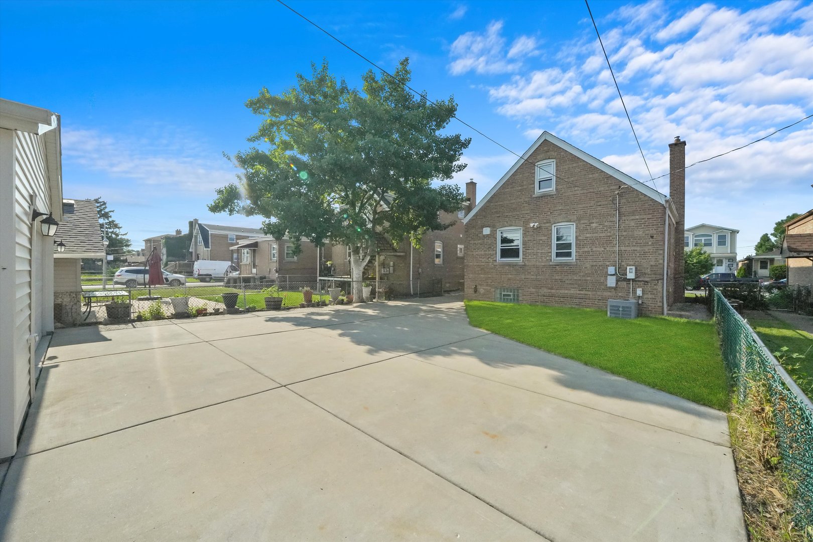 4353 West Marquette Road Chicago, IL 60629 - Photo 38 of 47 a view of a brick house next to a yard with big trees