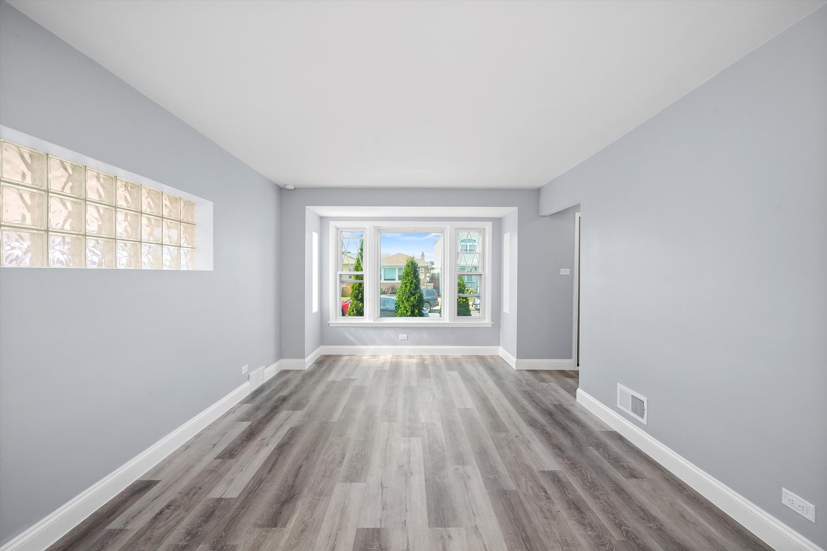 4353 West Marquette Road Chicago, IL 60629 - Photo 5 of 47 wooden floor in an empty room with a window