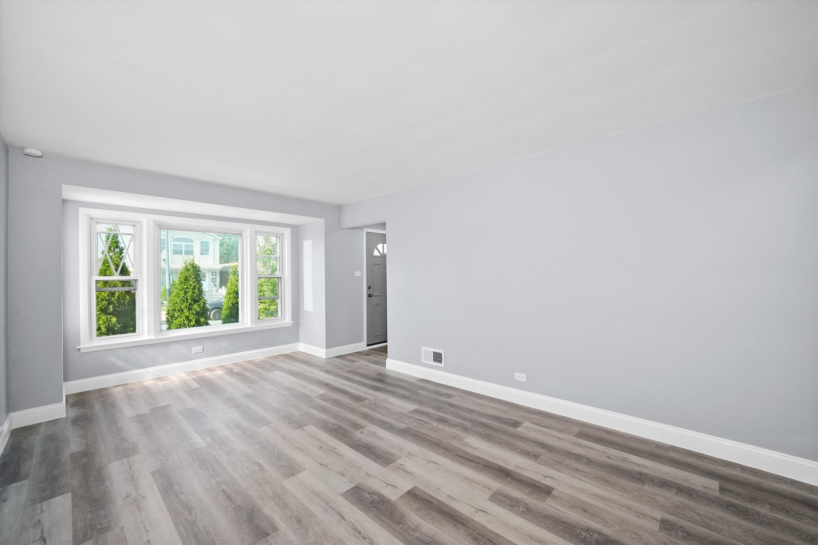 4353 West Marquette Road Chicago, IL 60629 - Photo 6 of 47 a view of an empty room with wooden floor and a window