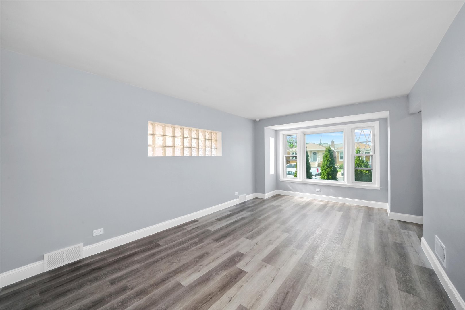 4353 West Marquette Road Chicago, IL 60629 - Photo 7 of 47 a view of an empty room with wooden floor and a window