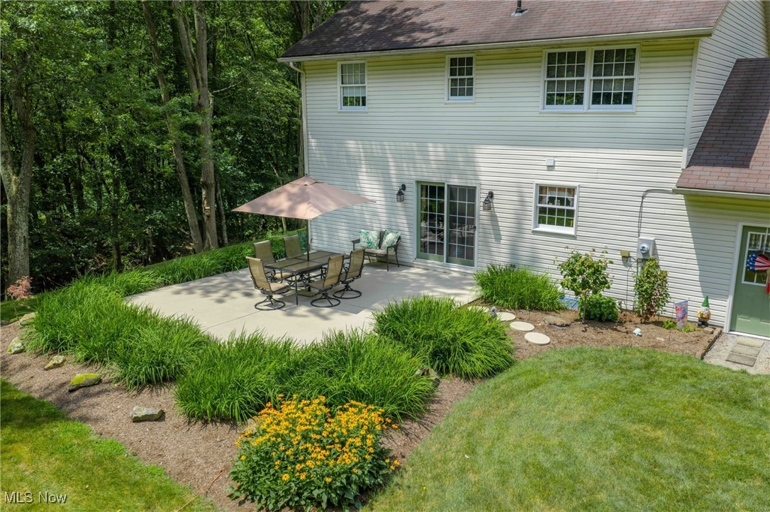 6535 Middle Run Road Dover, OH 44622 - Photo 23 of 40 Rear view of house featuring a shingled roof, a patio, and a lawn