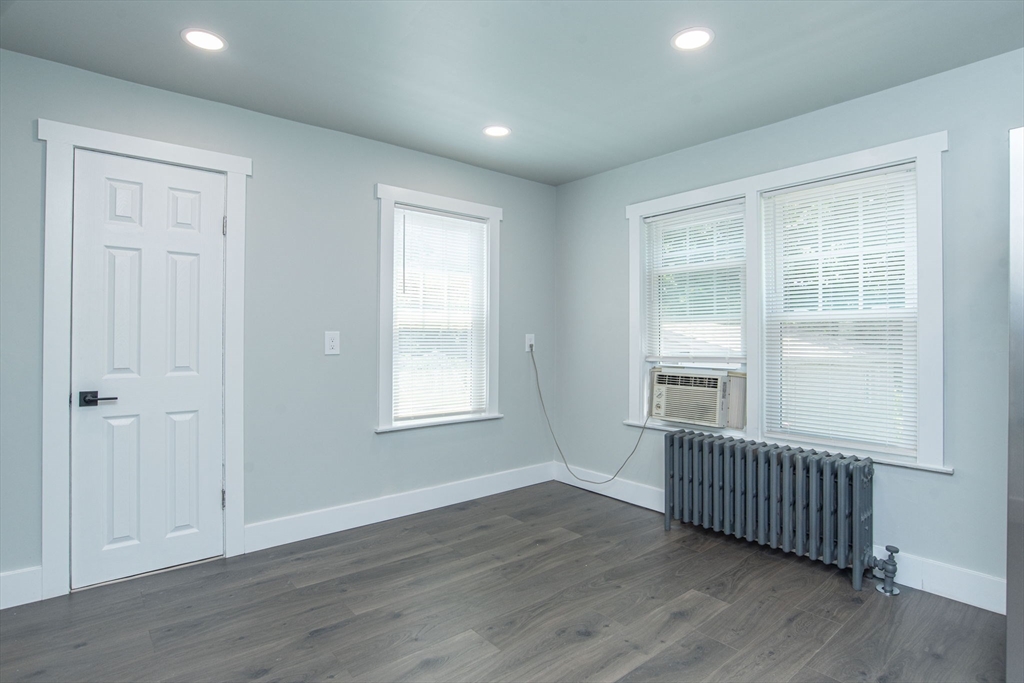 260 High Street Cumberland, RI 02864 - Photo 13 of 42 an empty room with wooden floor and windows