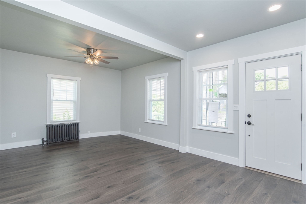 260 High Street Cumberland, RI 02864 - Photo 17 of 42 a view of an empty room with a window and wooden floor
