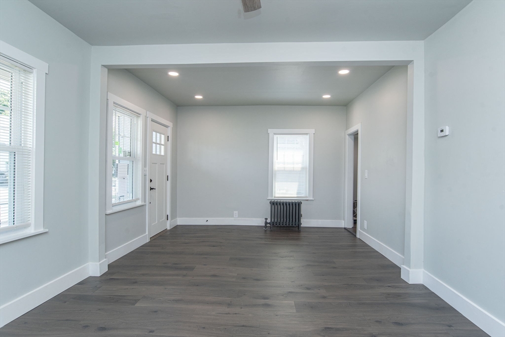 260 High Street Cumberland, RI 02864 - Photo 19 of 42 a view of an empty room with wooden floor and a window