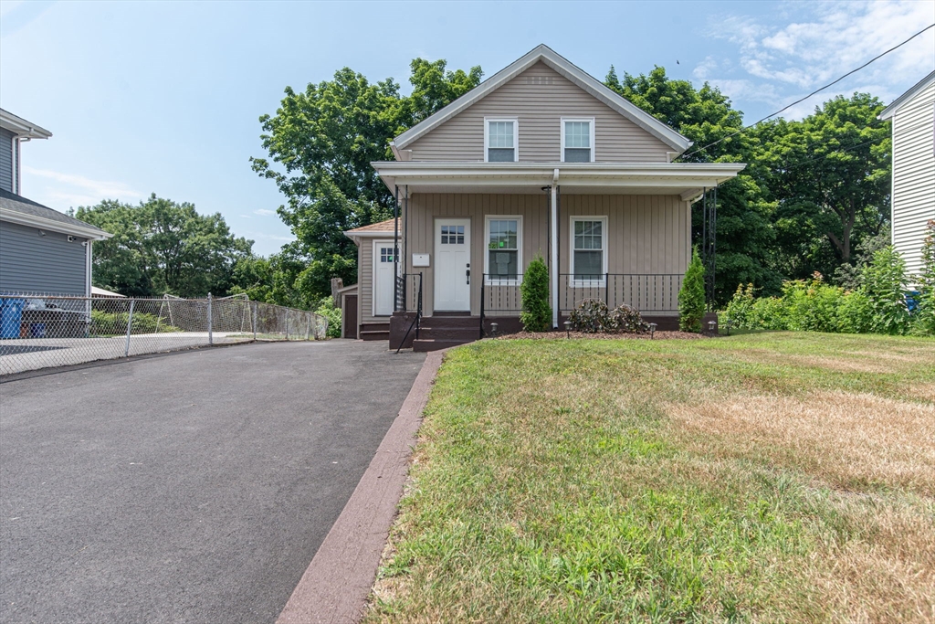 260 High Street Cumberland, RI 02864 - Photo 2 of 42 a front view of a house with a yard and potted plants
