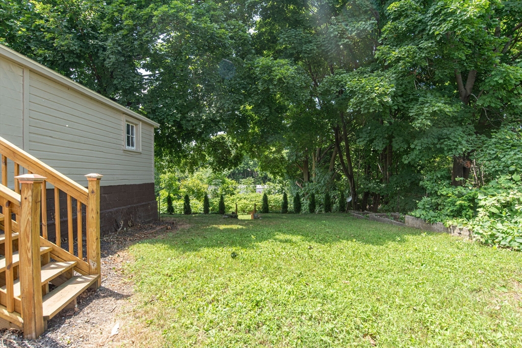 260 High Street Cumberland, RI 02864 - Photo 35 of 42 a view of a backyard with barn and large trees