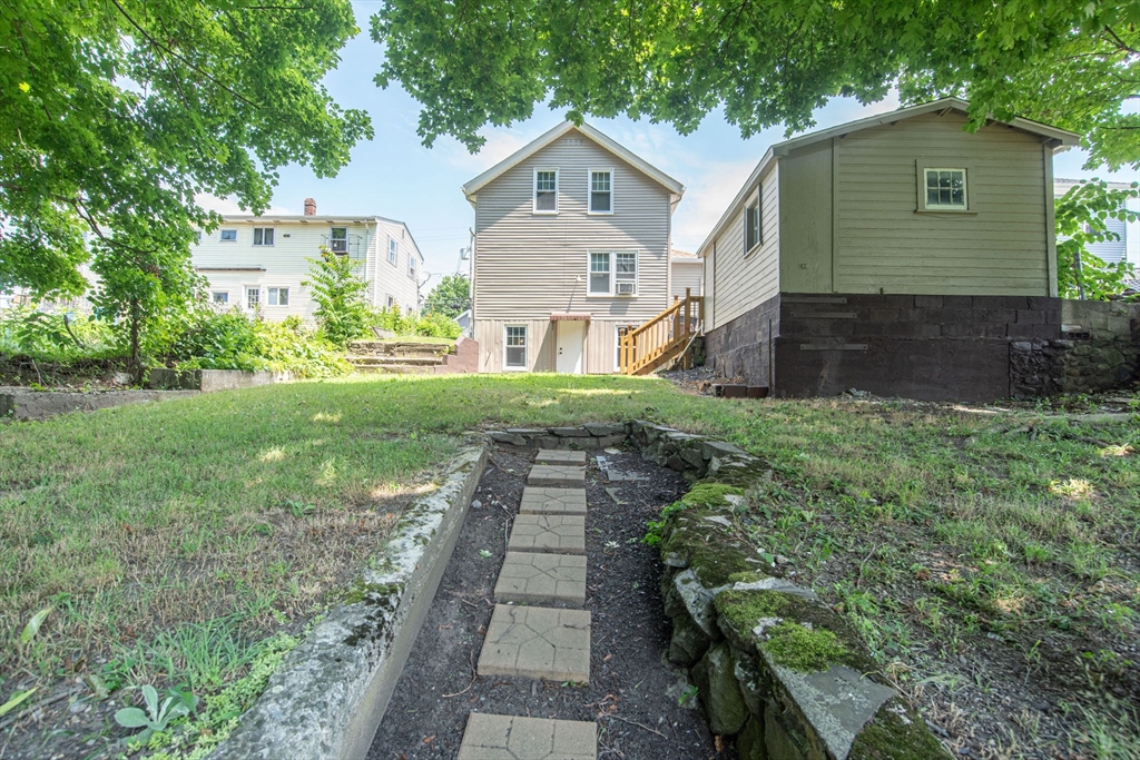 260 High Street Cumberland, RI 02864 - Photo 40 of 42 a front view of a house with a yard and trees