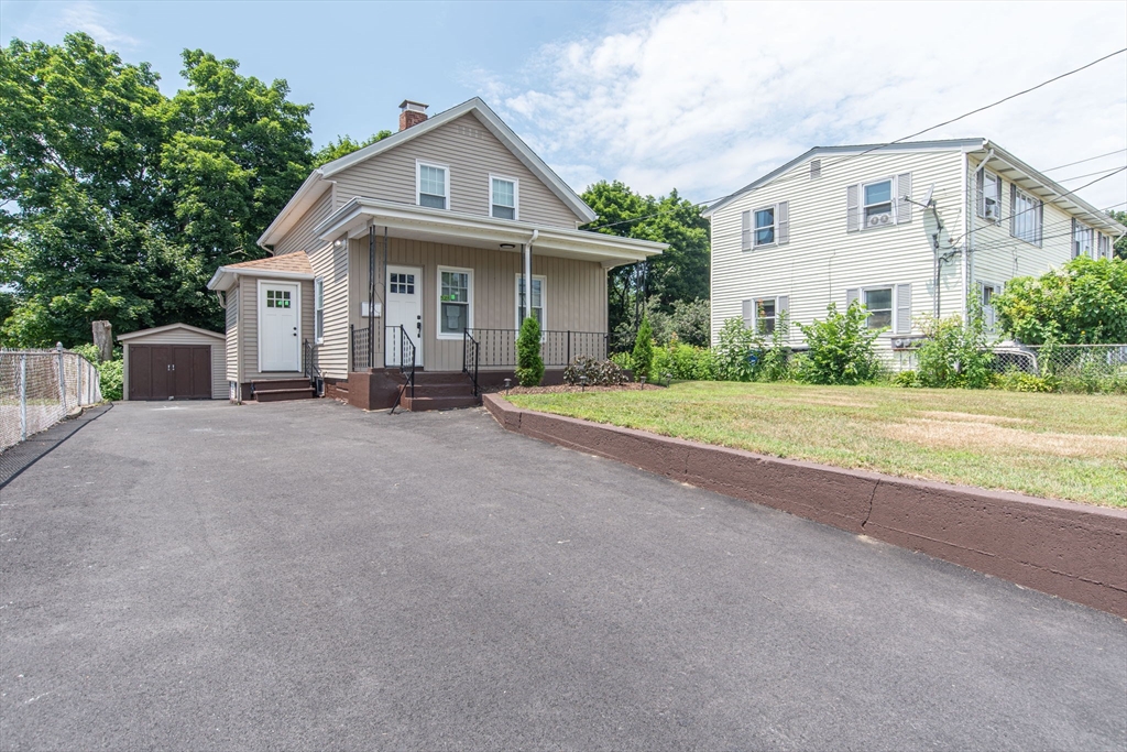 260 High Street Cumberland, RI 02864 - Photo 4 of 42 a front view of a house with a yard and garage