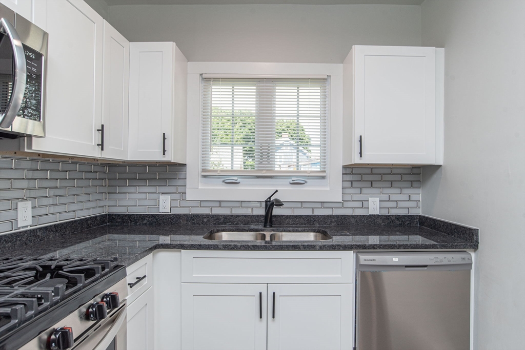 260 High Street Cumberland, RI 02864 - Photo 6 of 42 a kitchen with a sink and cabinets